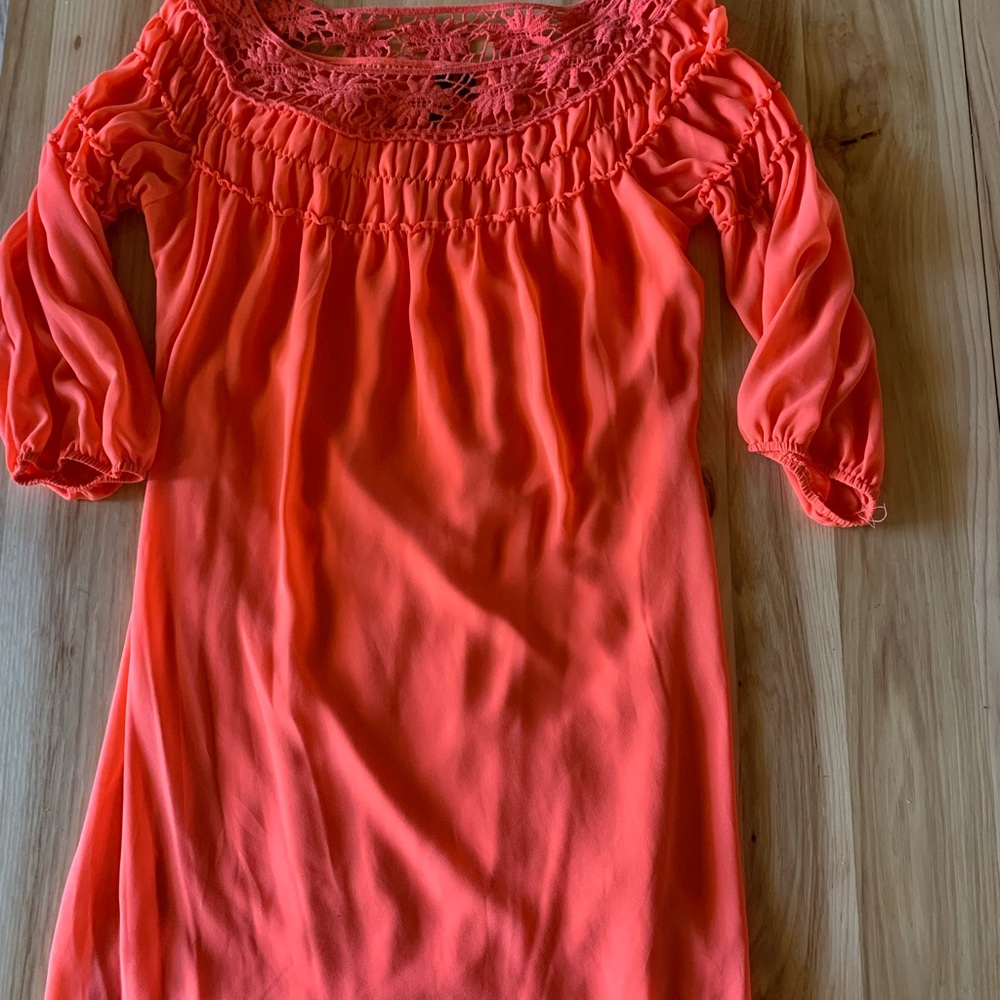Orange dress, crochet ontop stitching on bottom of dress.
